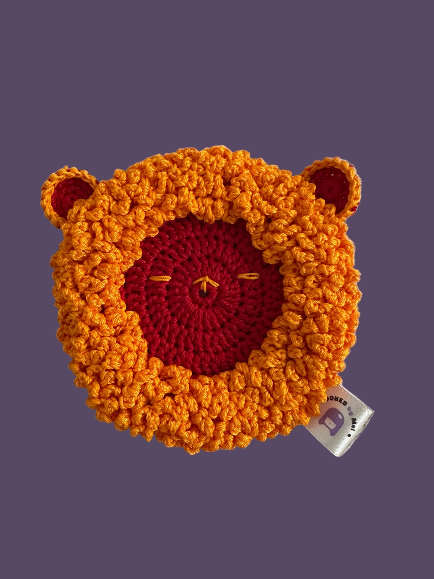 Crocheted sheep shaped coaster with orange hair