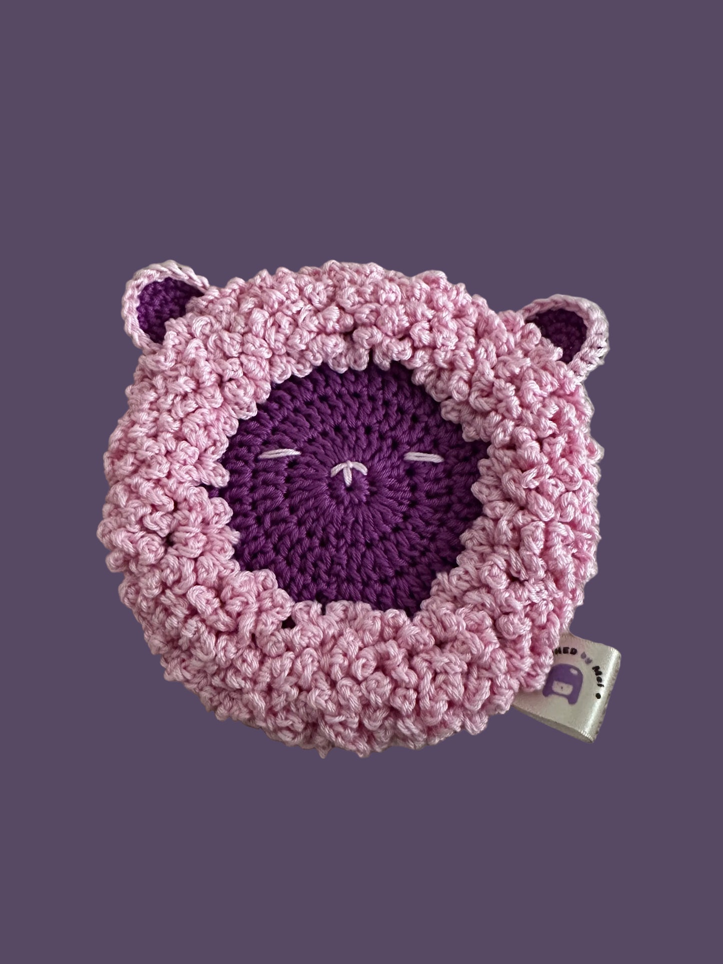 Crocheted pink and purple round coaster